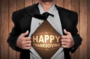 Business man tears open his shirt in a super hero fashion with happy thanksgiving writing